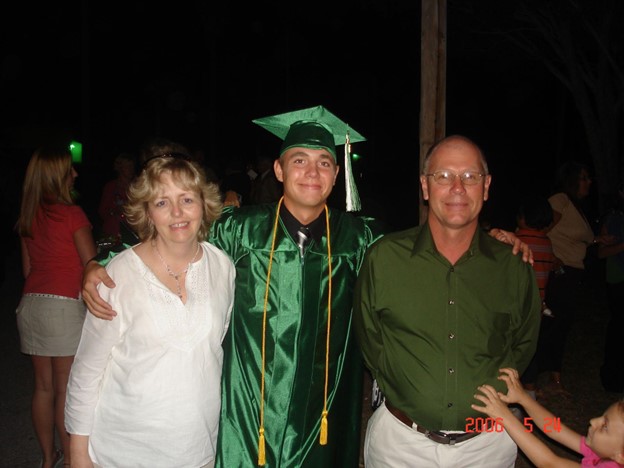 Kyle and his parents at his high school graduation in 2006.