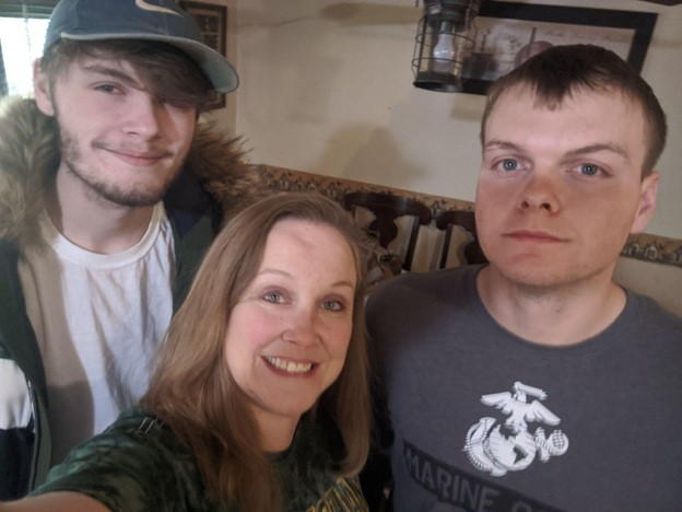 Angie (center) with her two sons, Cody (left) and Tyler (right).