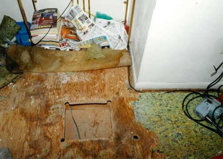 A crime scene photo of Nyesha’s apartment when they removed the flooring to recover the bullets that went through the floor.