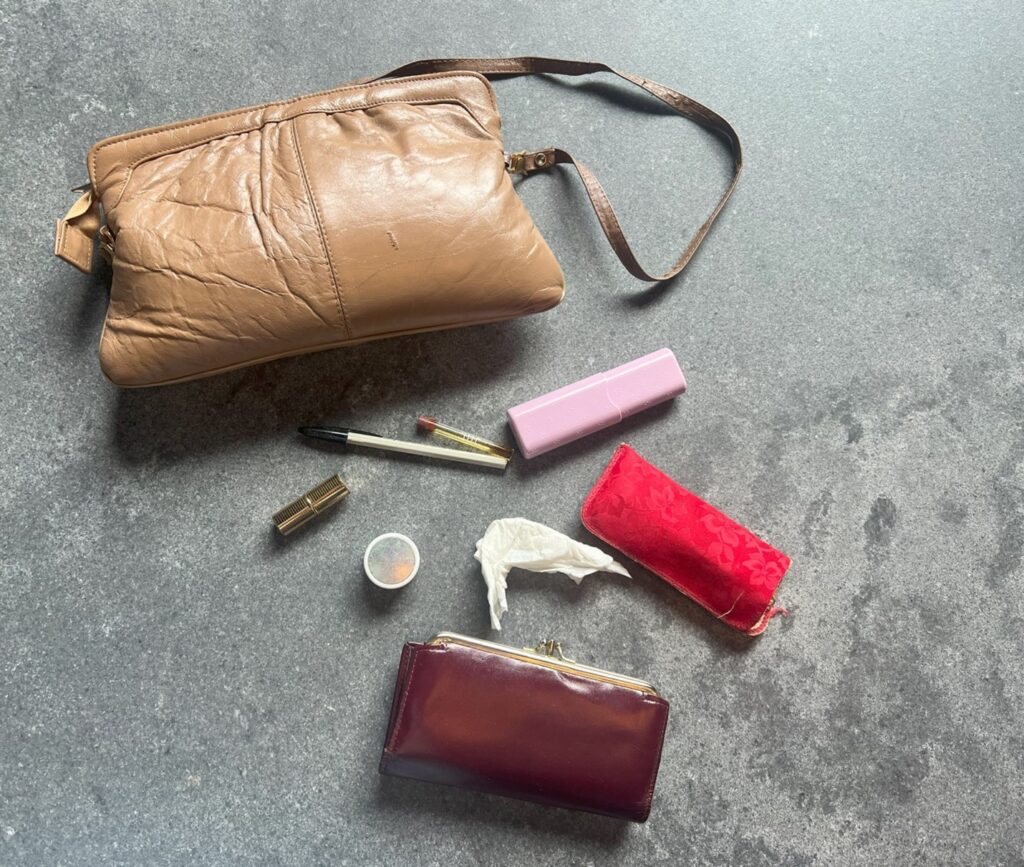 Ada's purse (and items inside of it) found on her dresser; items provided by family.