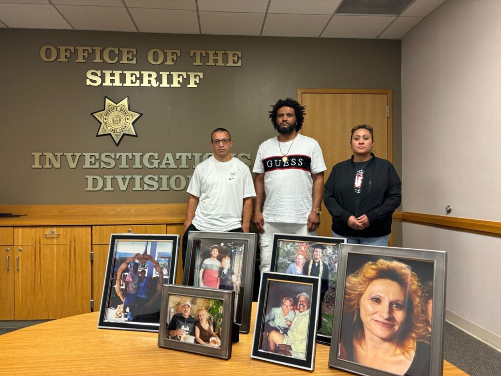 Alice's children, Richie, Jermaine, and Jenna (left to right) posing with photos of Alice and Ralph during our interview at the Salt Lake County Sheriff's Office.