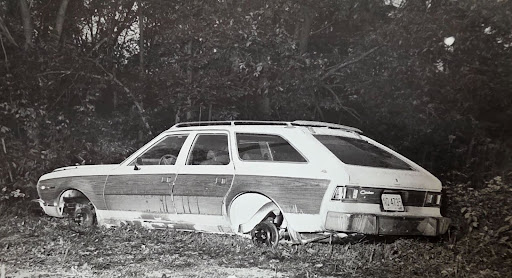 A photo of how Bob’s car was found– abandoned, with wheels and battery missing.