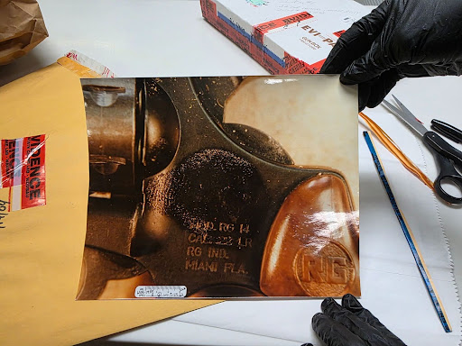 The photograph of the grease thumbprint on the revolver used in George’s murder.