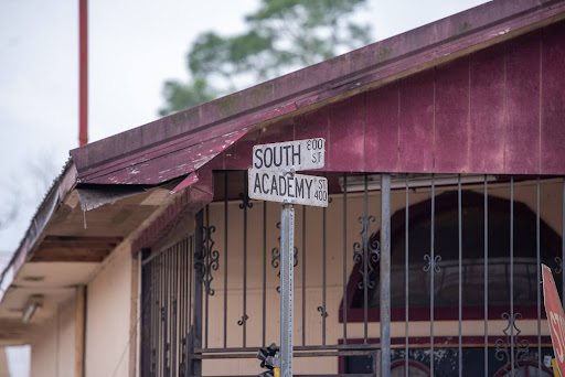 A detail shot of the street sign immediately outside the building that was formerly a nightclub called Added Attraction. The club is located at the corner of South and Academy streets in Opelousas, La. This was the last location where Albertha Young, also known as Candy, saw Sandra Burris.