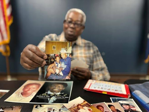 Robert’s brother, Willie Jones Jr., holding up a photo of him.