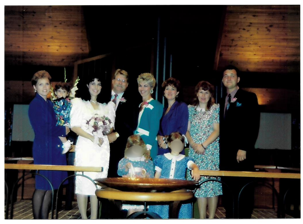 Photograph at Jeff and Shelby’s wedding. (Second from left: Shelby Nichols in the white dress. Third from right: Wanda Schmitt in the blue dress. Far right: Jeff Nichols. Second from left: Shelby Nichols in the white dress. Third from right: Wanda Schmitt in the blue dress. Far right: Jeff Nichols.